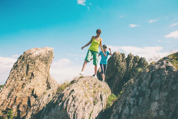 两个女孩爬上山顶 户外活动 在阳光明媚的日子里散步朋友 — 图库照片