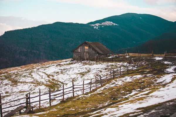 Old wooden house in the mountains. Wooden hut in the Ukrainian Carpathians. Shelter for tourists. House for shepherds and pasture.