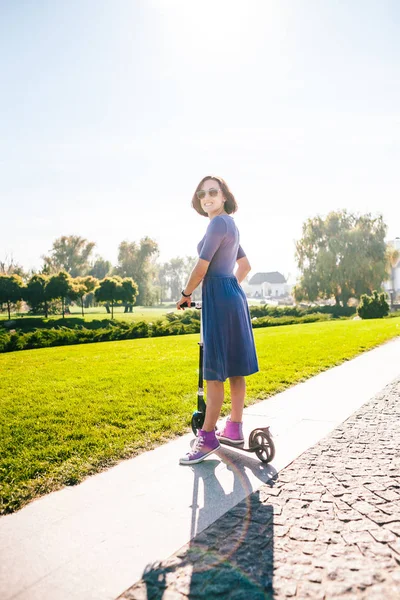 Woman Riding Scooter Girl Dress Rides Scooter Park Brunette Pushes — Stock Photo, Image