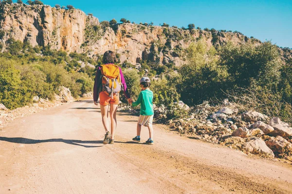 산악도로에 그의 어머니와 함께 산책 하는 소년. — 스톡 사진