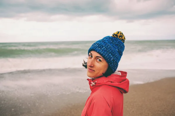 Portrait of a woman looking at the winter sea.