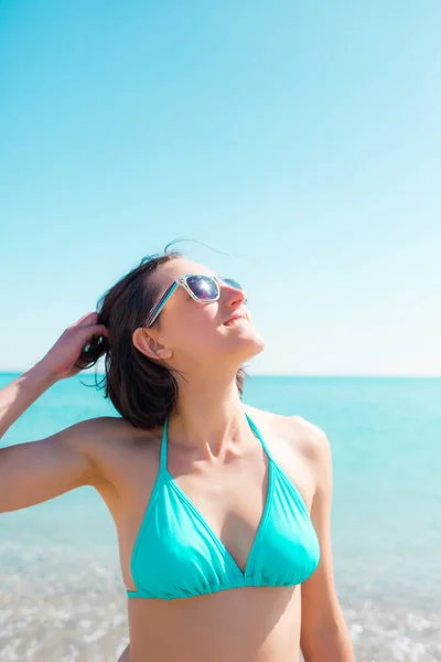 Girl smiling near the ocean Stock Picture