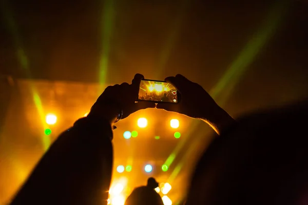 Shooting a concert on a smartphone.