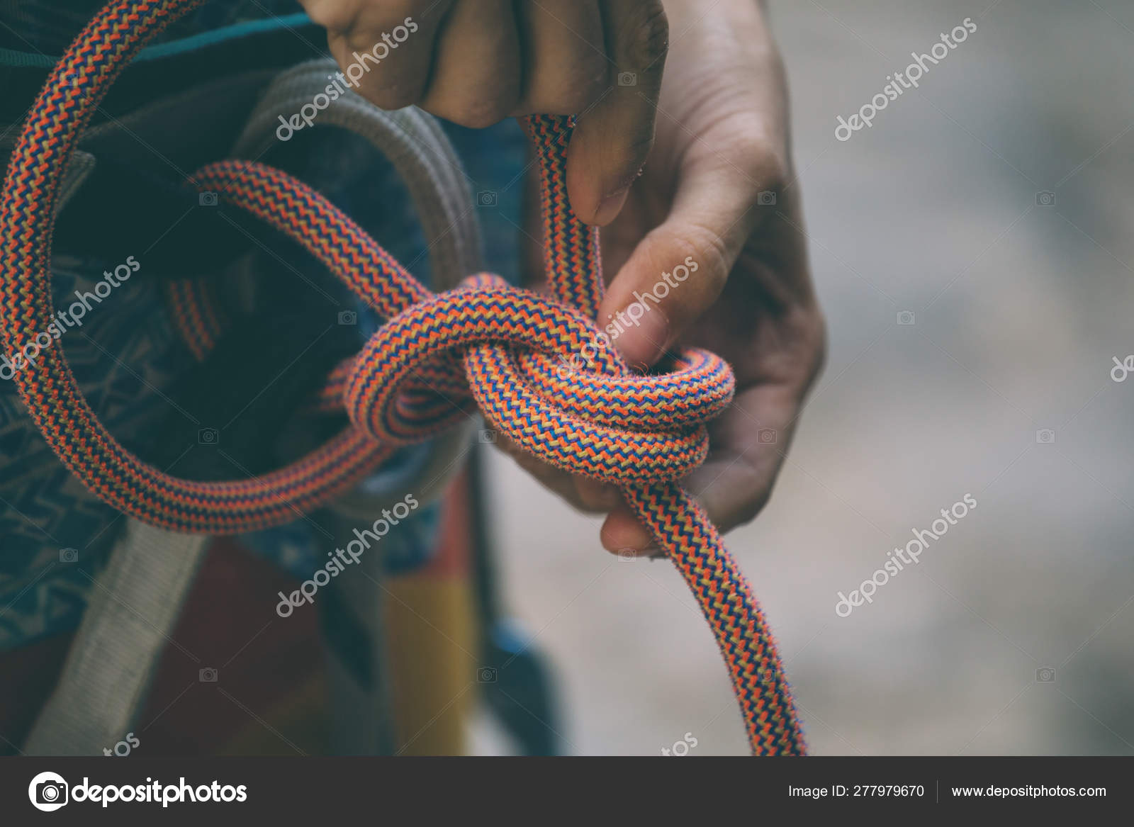 Rock climber tying a safety knot. Stock Photo by ©zhukovvvlad 277979670