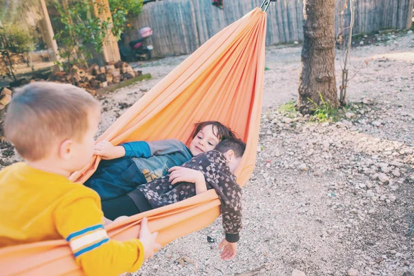 子供たちはハンモックで遊んでいる. — ストック写真