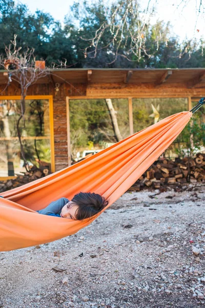 The boy lies in a hammock. — Stock Photo, Image