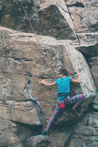 La chica sube a la roca de granito . — Foto de Stock