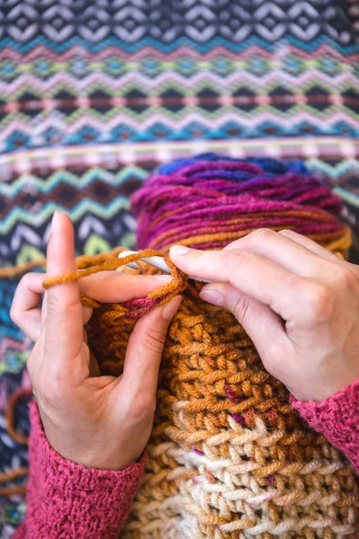 The woman is crocheting.