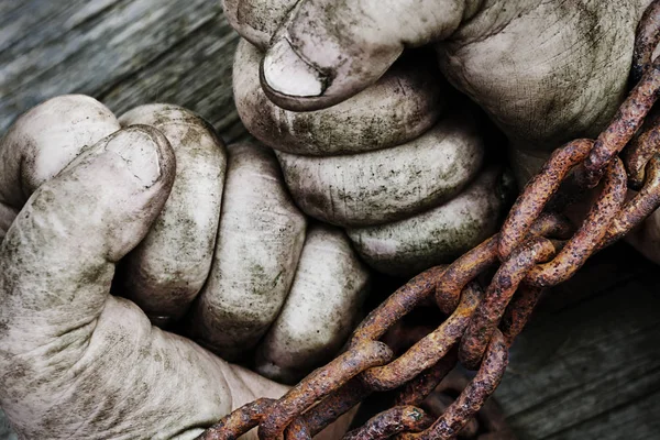 Potężny brudne męskie dłonie zaciśnięte w pięści, powiązane z zardzewiały łańcuch. — Zdjęcie stockowe