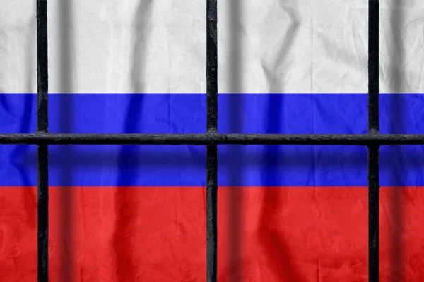 Ρωσική σημαία πίσω από μαύρα Μεταλλικά κάγκελα φυλακής με σκιές — Φωτογραφία Αρχείου