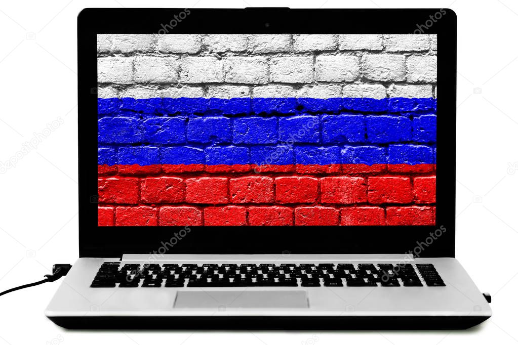 Isolated laptop with the Russian flag painted on a brick wall on the screen