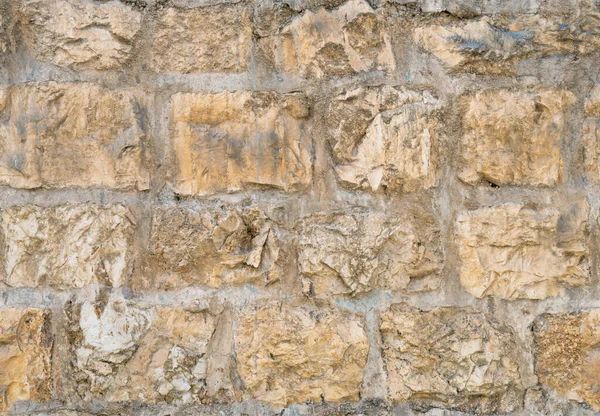 Parede de pedra antiga medieval em Jerusalém velho fundo textura sem costura . — Fotografia de Stock