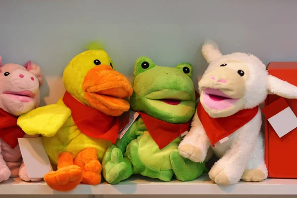 Many stuffed animal toys on shop shelves display
