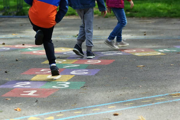 Closeup Kids Feet Jumping Playing Hopscotch School Yard — Stock Photo, Image