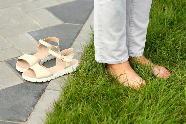 Close Van Vrouwelijke Blote Voeten Zomer Gras Contrasterende Stedelijke Asfalt — Stockfoto