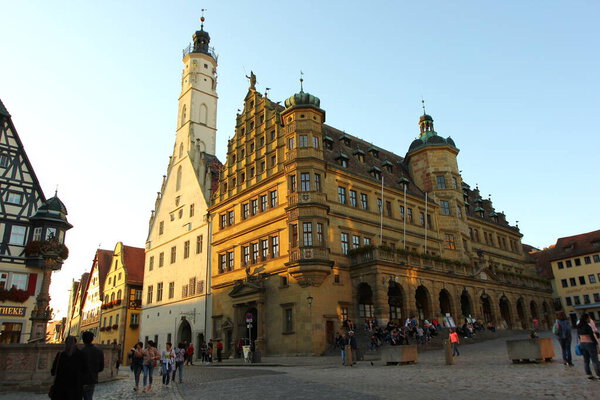 Rothenburg ob der Tauber, Germany - October 14, 2019: Old picturesque buildings at sunset at the central square