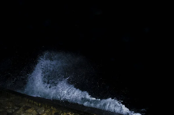 Splashing wave on the Black sea in the night.