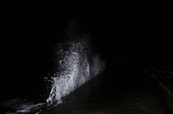 Splashing wave on the Black sea in the night.