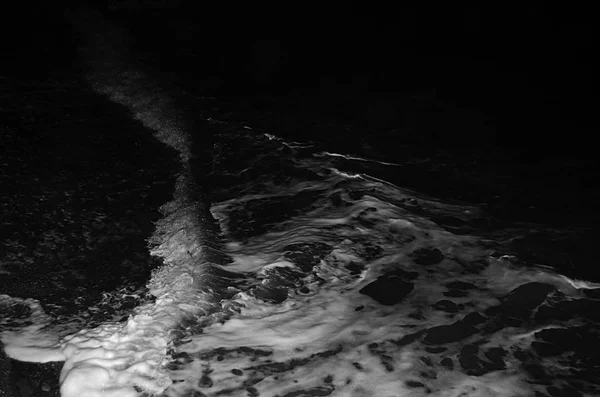 Splashing wave on the Black sea in the night.