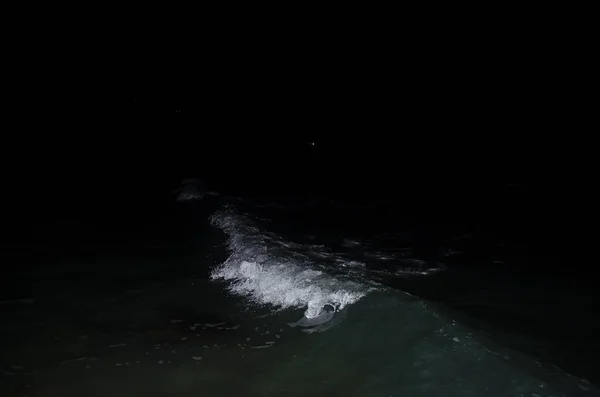 Splashing wave on the Black sea in the night.