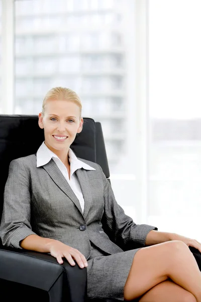 Portrait of a corporate executive woman sitting on a business chair at office