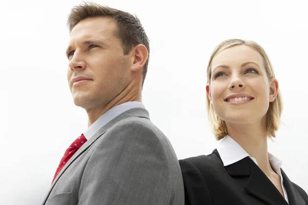 corporate sales team - young businessman with pretty woman looking away - portrait