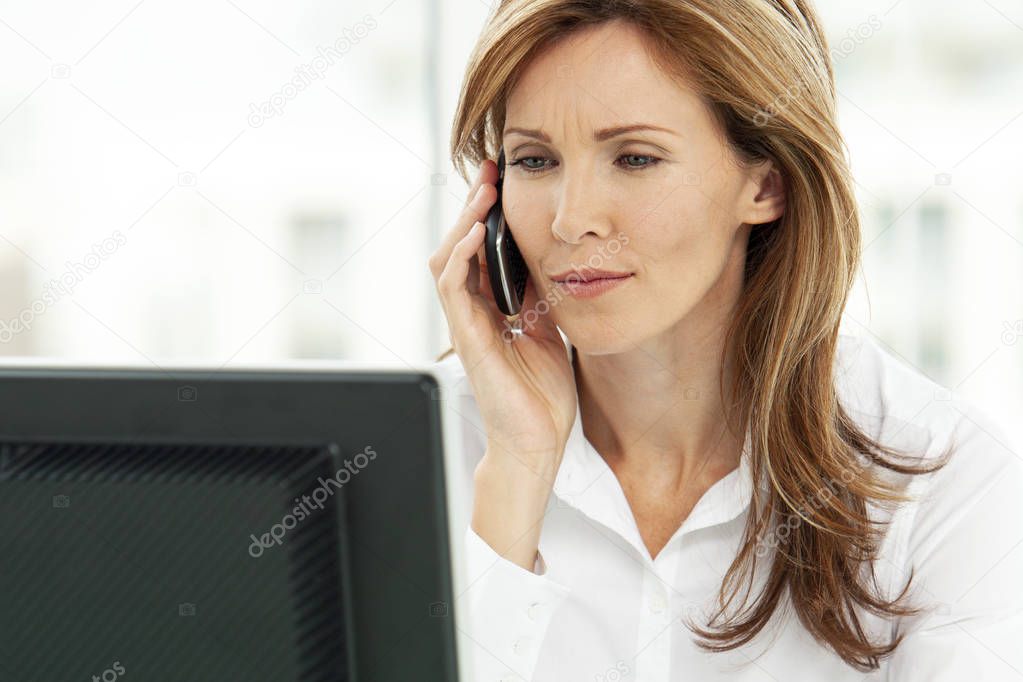Woman on the phone - businesswoman using phone in office - corporate executive