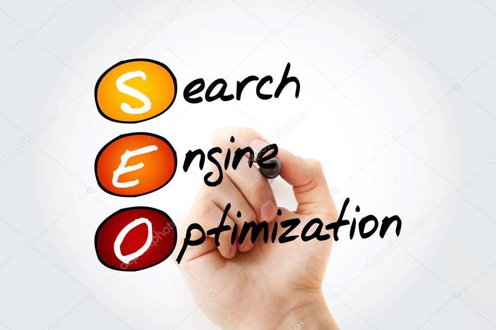 Hand writing SEO (Search Engine Optimization) with marker, business concept