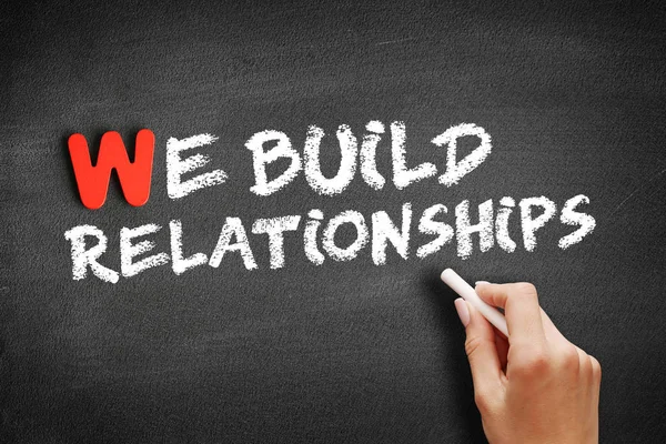 We Build Relationships text on blackboard — Stock Photo, Image