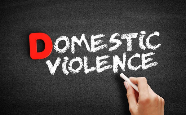 Domestic violence text on blackboard — Stock Photo, Image