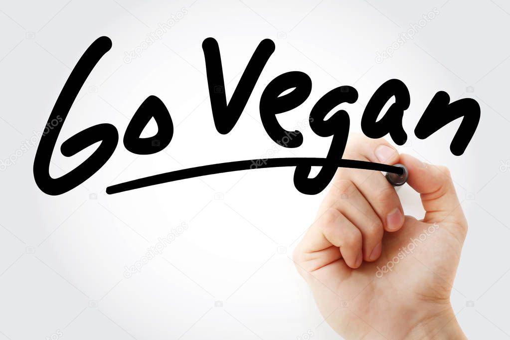 Hand writing Go Vegan text with marker