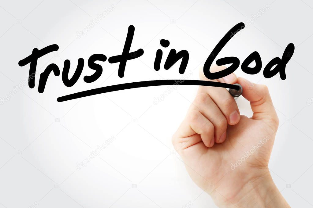 Hand writing Trust in God with marker
