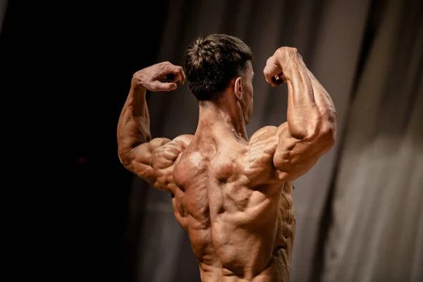 athlete bodybuilder pose back double biceps bodybuilding competitions