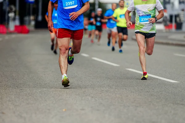 group of men runners run in street of city marathon race