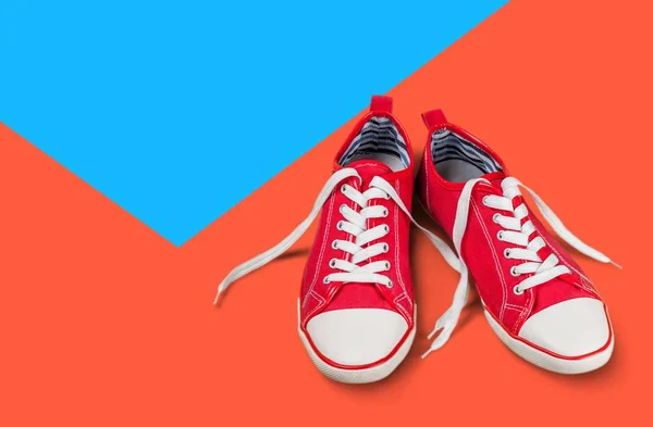 Pair of red gum shoes, close-up view