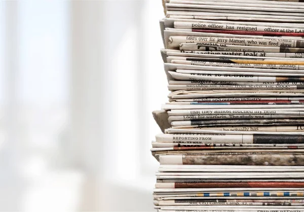 Pile of newspapers on background, close-up view