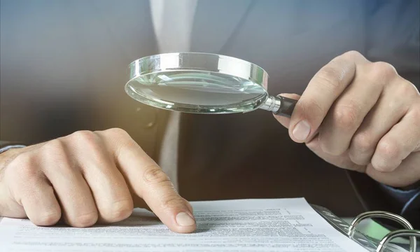 Businessman Holding Magnifying Glass close-up view