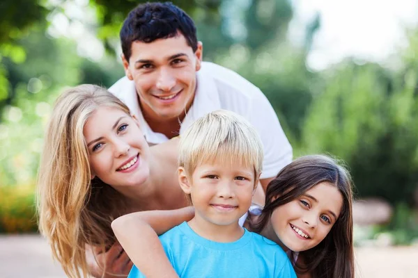 Lovely family hugging in park outdoor