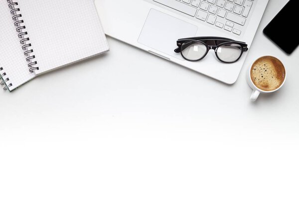 Modern workplace with laptop and stationery top view 