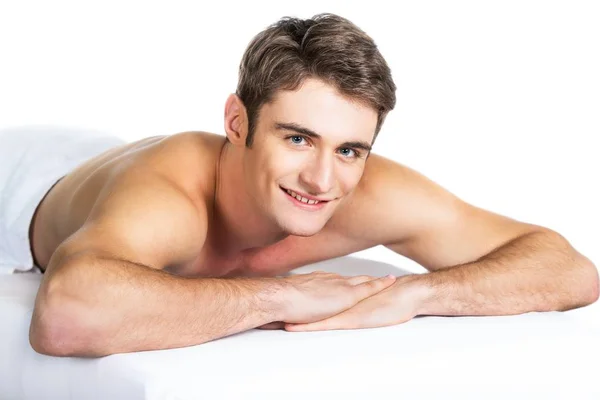 Smiling man lying on a massage table — Stock Photo, Image
