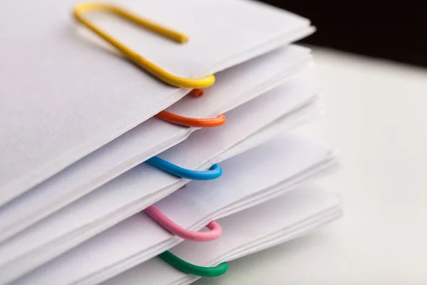 File folders with documents and bright paperclips