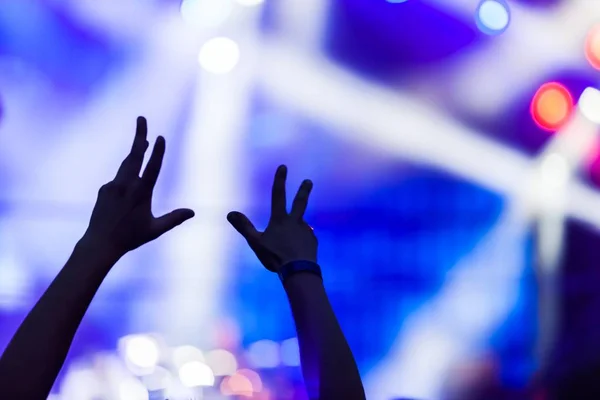 Raised Hands with Stage Lights on Background — Stock Photo, Image