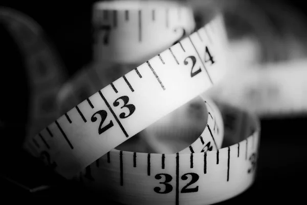 Measuring tape isolated on dark background