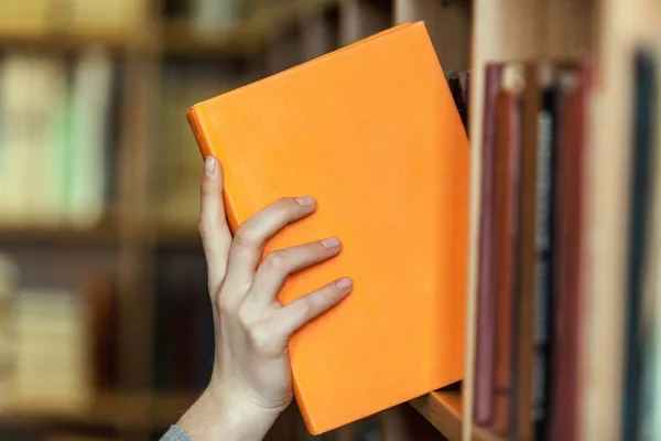 Hand holds book.