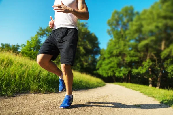 Young man running on a rural road — Stock Photo, Image