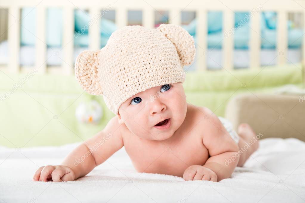 Infant Baby Lying On Tummy Wearing A Bear Hat