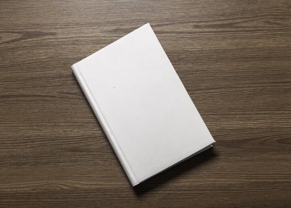 book with blank cover on wooden background