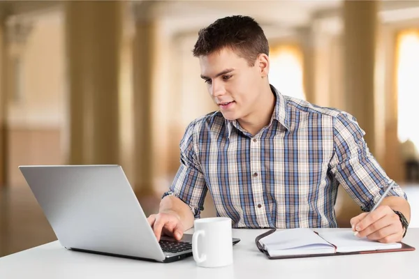 Щасливий молодий чоловік працює на ноутбуці — стокове фото