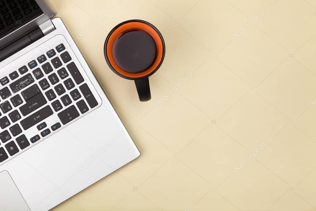 Top view laptop computer with cup of coffee on office desk table.