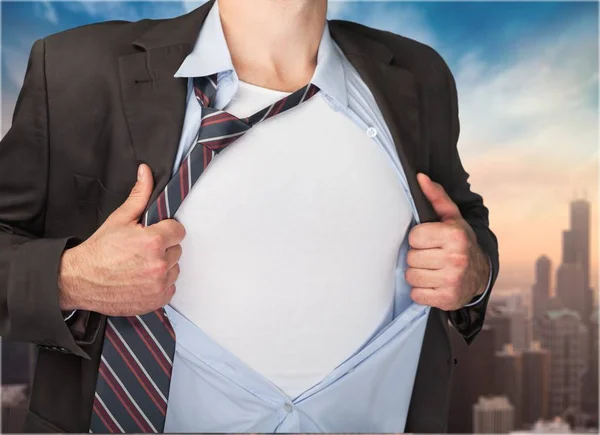 Businessman tears shirt on himself